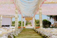 an outdoor wedding setup with white and pink flowers