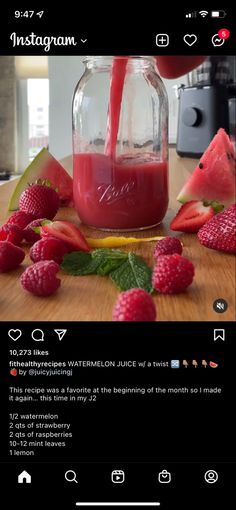 someone is pouring juice into a jar with strawberries and raspberries on the table