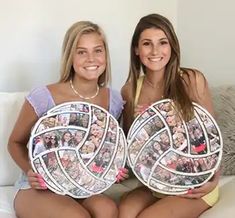 two beautiful young women sitting on top of a white couch holding up plates with photos