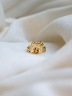 C E L E S T I A L ∙ C I T R I N E ∙ R I N G  Find the matching pendant at https://www.etsy.com/listing/1803089707/celestial-citrine-necklace-24k-gold The ring is crafted with 24k gold vermeil over 925 sterling silver. At its centre, a stunning round-cut citrine gemstone radiates warmth and light, surrounded by a unique sunrise-inspired design that symbolizes new beginnings and positivity. The intricate detailing of the sun rays adds a touch of elegance, making this ring a perfect statement piece Gold Citrine Stackable Jewelry, Gold Rings With Topaz Birthstone, Yellow Halo Jewelry For Gifts, Celestial Gold Rings With Gemstone, Gold Celestial Rings With Gemstone, Adjustable Gold Citrine Rings, Gold Citrine Open Ring Jewelry, Yellow Halo Rings As A Gift, Handmade Gold Citrine Rings