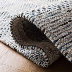 a blue and white rug on the floor with a hole in the middle that has been cut open