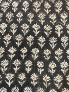 black and white floral print fabric with small flowers on the side, in an intricate pattern