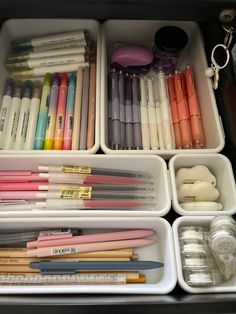 an organized drawer filled with pens and markers