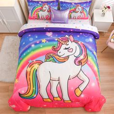 a bed with a rainbow unicorn on it