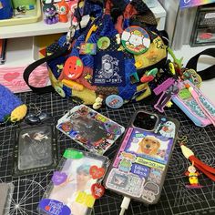 the contents of a purse sitting on top of a table next to scissors and other items