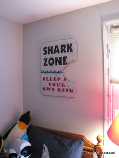 there is a sign on the wall that says shark zone and keep your own kiss