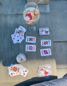 playing cards and drinks are on the ground