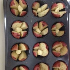 apples are being cooked in a muffin tin