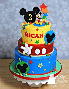 a mickey mouse birthday cake with stars and numbers on the top, is ready to be eaten