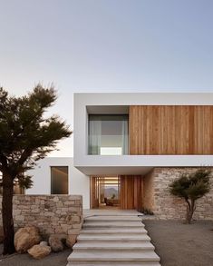 the stairs lead up to this modern house