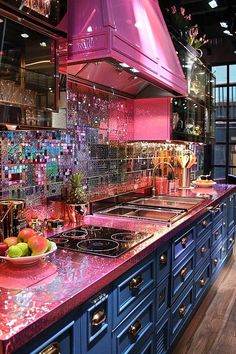 a kitchen with blue cabinets and pink counter tops is pictured in this image, there are fruit on the counter