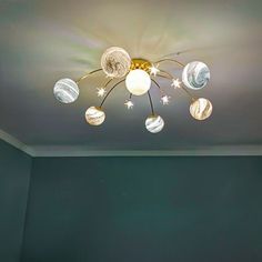 a ceiling light in a room with green walls and white lights on the ceiling above it