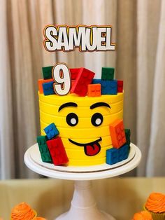 there is a cake made to look like a lego face with the number 9 on it