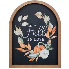 a wooden frame with a painted fall in love sign on the front and back side