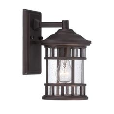 an outdoor wall light with a caged glass bulb on it's back end