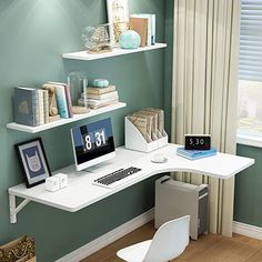 a corner desk with a computer on it in front of a window and bookshelves