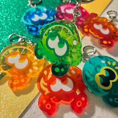 several different colored key chains with mickey mouse faces on them, sitting on a table