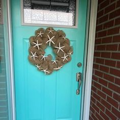 a blue door with a starfish wreath on it