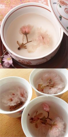 four bowls with flowers in them sitting on a table