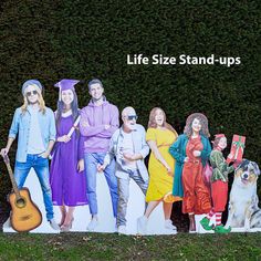 a group of people standing next to each other in front of a wall with the words life size stand - ups on it