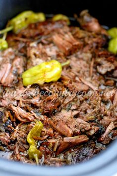 shredded meat and vegetables in a bowl with the words slow cooker pulled pork on it