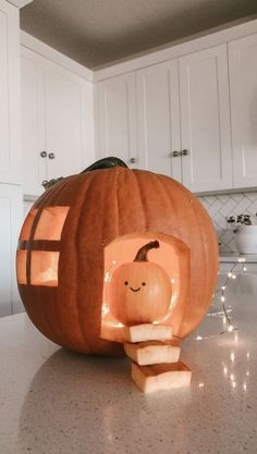 a pumpkin shaped like a house sitting on top of a kitchen counter