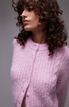 Cable stitching makes a subtle textural statement on a wool-kissed crewneck cardigan knit to a perfectly cropped silhouette. Front button closure Crewneck Long sleeves Ribbed cuffs and hem 47% polyester, 37% nylon, 11% acrylic, 5% wool Machine wash, dry flat Imported