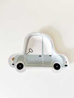 a paper model of a small car on a white background