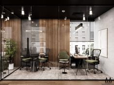 an office with glass walls and wooden paneling on the wall is furnished with green chairs