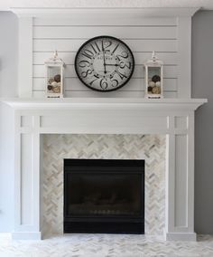 a white fireplace with a clock above it