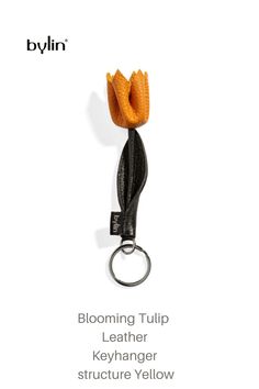 a brochure ad with an orange flower on it's side and the words blooming tulip leather keychain structure yellow