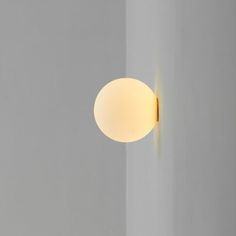 a light that is on in the middle of a room with white walls and flooring