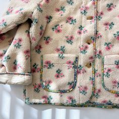 Brighten up the chilly season with a floral teddy jacket that's both cozy and chic. The floral pattern adds a lively touch to your winter wardrobe, perfect for day or night. Pair it over your favorite casual ensemble and complete your outfit with a hat. Get ready to make a delightful impression wherever you go!