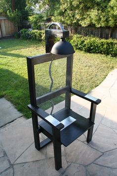 a chair with a bird cage on it sitting in front of a fire hydrant