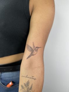 a woman with a small tattoo on her arm