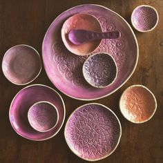 purple bowls and spoons on a wooden table