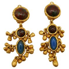 YVES SAINT LAURENT vintage gold tone dangling earrings (clip-on) embellished with faux stones glass cabochons and gilt charms. Embossed YSL Made in France. Indicative measurements : max. height approx. 6.9 cm (2.72 inches) / max. diameter approx. 1.8 cm (0.71 inch). Weight per earring : approx. 22 grams. Material : Gold tone metal hardware / Glass. NOTES - This is a preloved vintage item, therefore it might have imperfections. - Colors may differ slightly from actual product appearance due to differences in lighting conditions. - As a buyer, you are fully responsible for customs duties, other local taxes and any administrative procedures related to imports into the country of destination. Ysl Vintage Jewelry, Ysl Vintage, Saint Laurent Vintage, Ysl Beauty, Faux Stone, Dangling Earrings, Gold Tone Metal, Made In, Vintage Gold