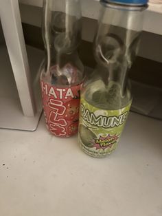 two empty soda bottles sitting next to each other