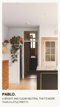 a kitchen with white walls and wood flooring is featured in the magazine pablo