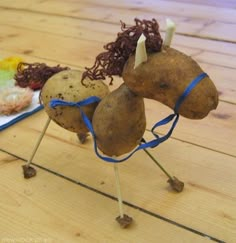 a toy horse made out of potatoes on a wooden table