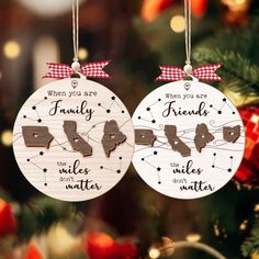 two ornaments hanging from a christmas tree with the words family and friends written on them