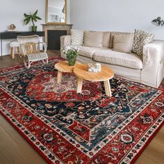 a living room filled with furniture and a red rug