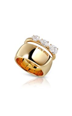 a gold ring with three diamonds on it