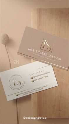 two business cards on top of each other with the letter s in gold and white