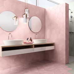 a bathroom with two sinks and mirrors on the wall, pink tiles in the background