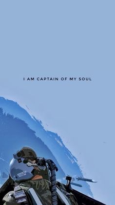 a man sitting on top of a snow covered ski slope next to the words i am captain of my soul