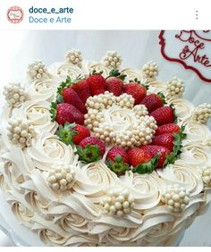 there is a large cake decorated with strawberries and cream frosting on the top