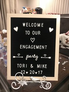 a welcome sign on a table in front of a baby's birth announcement board