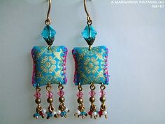 two pairs of earrings with beads hanging from them