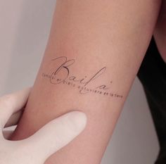 a woman's arm with a tattoo that reads, balia and the words written in cursive writing